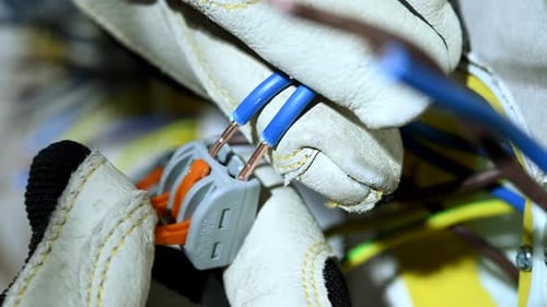 Hands Connect Electrical Wires to Connector Close Up