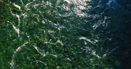Low Altitude Flight Over Fresh Fast Mountain River with Rocks at Sunny Summer Morning.
