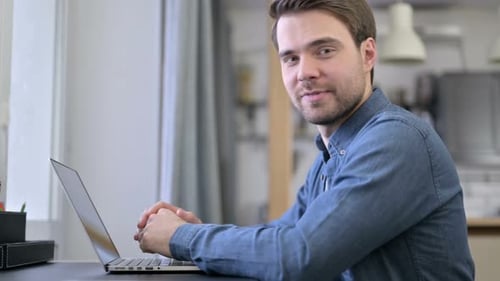 Beard Young Man Smiling at Camera in Office