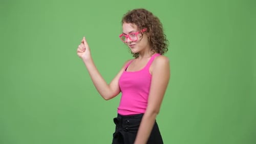 Woman in Pink Gesturing on Green Background