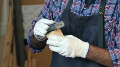 Carpenter Working with Wooden Bar in Workshop