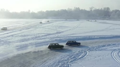Vintage Cars Drifting on Snowy Winter Terrain