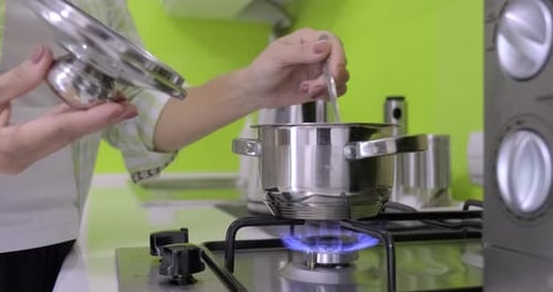 Cooking Food in a Shiny Stainless Steel Pot