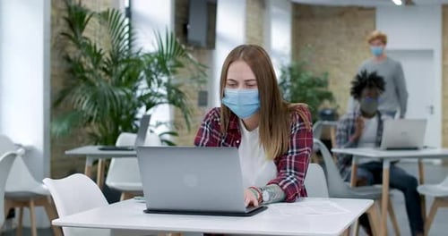 Woman Working on Laptop in Shared Office Space