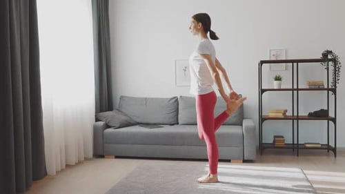Woman Doing Leg Stretches at Home
