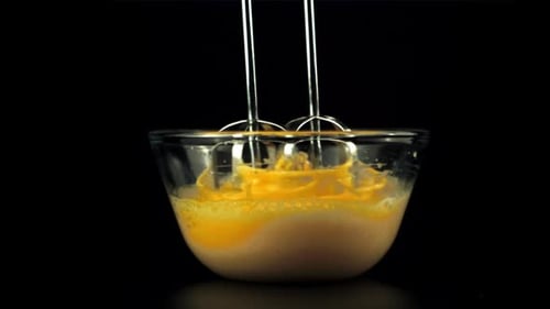 Super Slow Motion in the Transparent Bowl is Whipped Raw Eggs with a Mixer