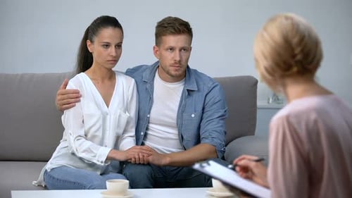 Couple Discussing Issues With Therapist in Office