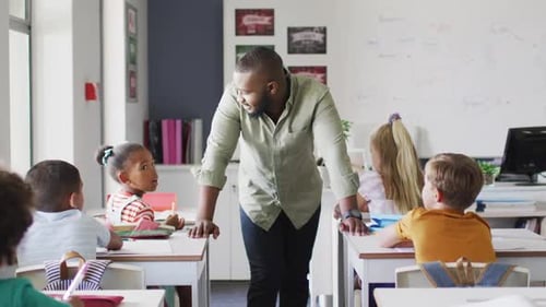 Teacher Speaking to Elementary School Students in Classroom