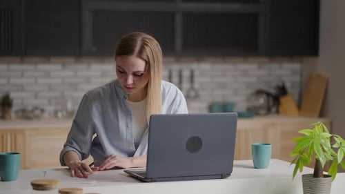 Woman Drawing, Using Laptop in Modern Kitchen