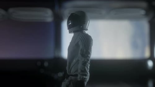 Astronaut going through the tunnel to another compartment of futuristic spaceship