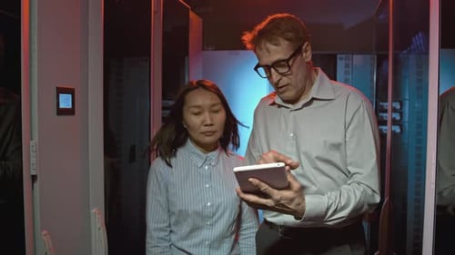 Colleagues Walking Through Data Center and Talking