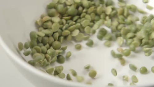 Green Peas Fall On White Dish