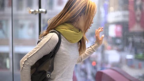 Woman looking outside through the window