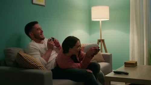 Playful Couple Enjoying Video Games at Home