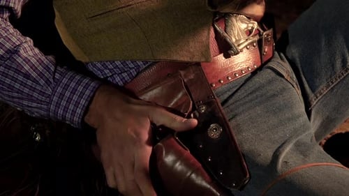 Man Removing a Revolver From Holster