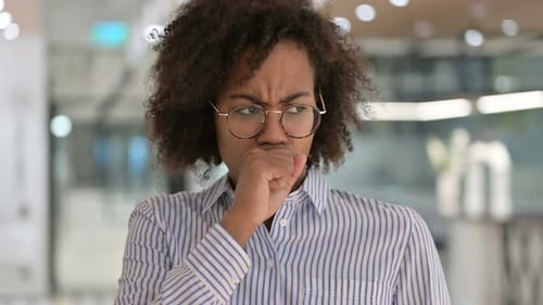 Young Adult Woman Coughing in Workplace