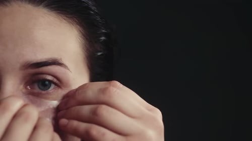 Woman Applying Cosmetic Eye Patches, Close Up Beauty