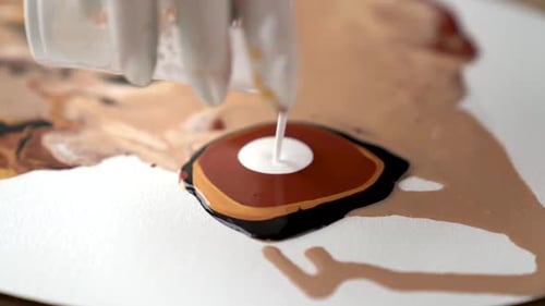 Paints Poured onto Canvas to Create Art