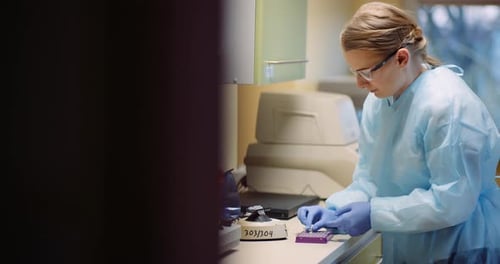 Woman Scientist Working in Laboratory with Pipette