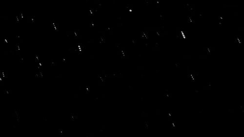 Snowflakes Illuminated By Light From the Lamp Fall Through