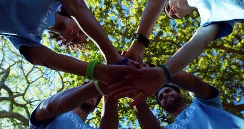 Diverse Group Stacking Hands Together in Unity