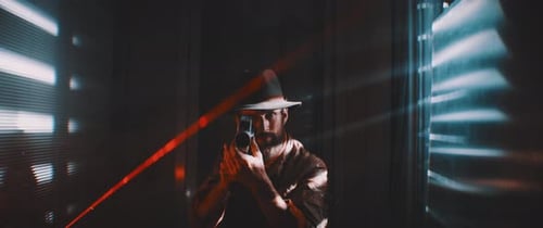 Man with Retro Camera in Dark, Stylish Lighting