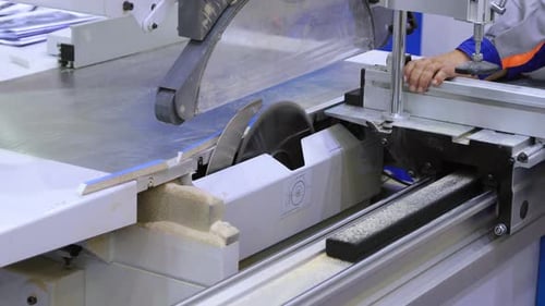 Worker Cutting Wood with an Industrial Saw