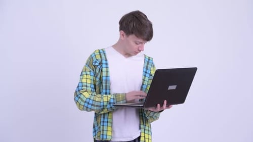Young Adult Typing on Laptop Indoors