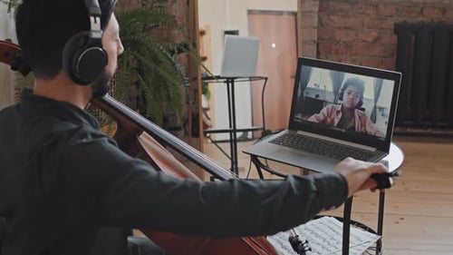 Man Playing Cello with Child in Virtual Lesson