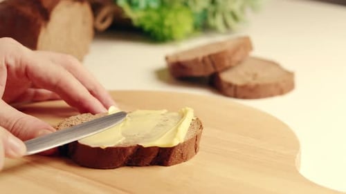 Spreading Butter on Slice of Bread with Knife