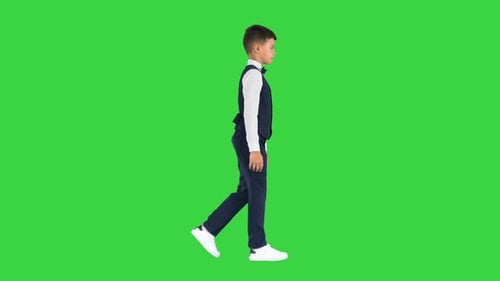 Little Boy Waistcoat Bow Tie Walking Looking Straight Ahead Green Screen Chroma Key