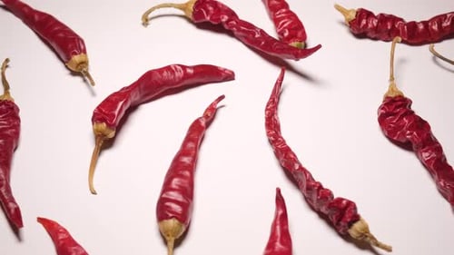 Dried Red Chili Peppers on White Surface