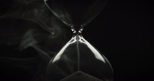 Hourglass Sand Trickling with Smoke in Close Up