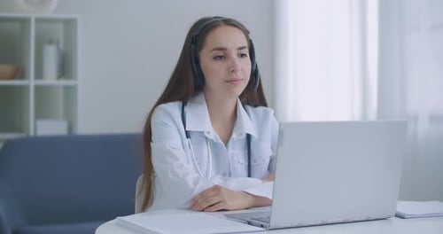 Woman Doctor Providing Telehealth Appointment Online