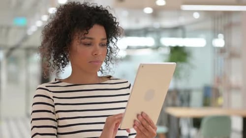 Woman Using Tablet Device in Modern Office