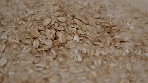 Oats Being Poured Into Bowl Of Milk