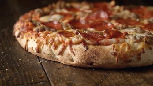 Pizza Cut with Pizza Cutter on Wooden Table