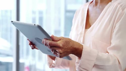 Senior Woman Using a Tablet Indoors Daytime