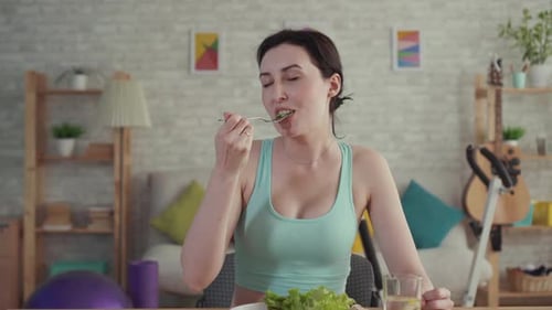 Woman Enjoying Healthy Salad and Cracker at Home