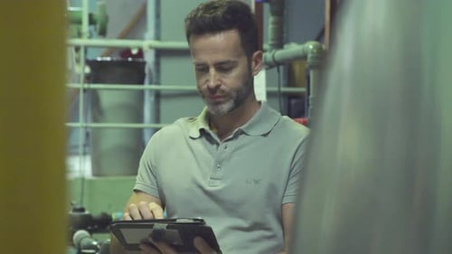 Industrial plant worker using digital tablet