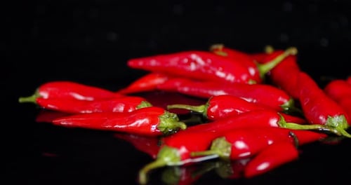 Fresh Red Chili Peppers Pile on Black Surface