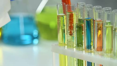 Close Up Hand Holding Red Liquid Test Tube