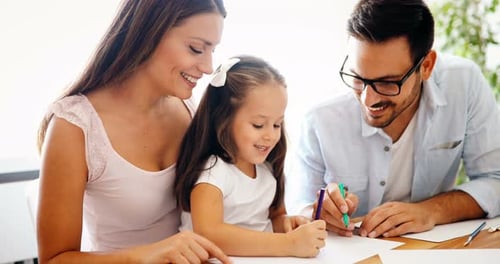 Family Drawing Together at Home with Colored Pencils