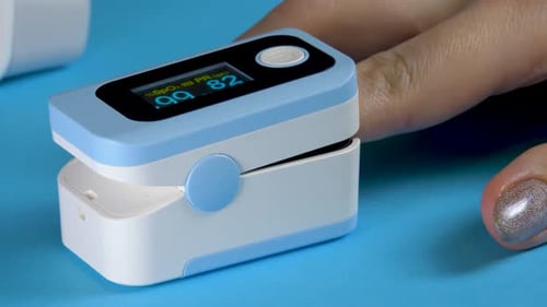 Finger in Pulse Oximeter Measuring Oxygen Saturation