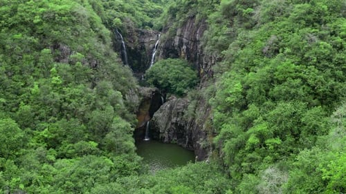 Camera is Flying Above Waterfall in Tropical Forest