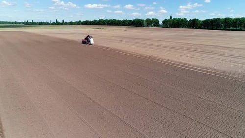Aerial View Tractor Plows the Land, Processing the Field Before Sowing, Spring