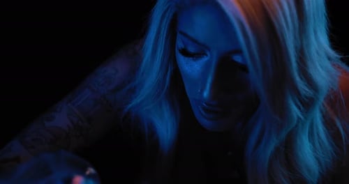 Close up of a young female tattoo artist during her work in studio. BMPCC 4K