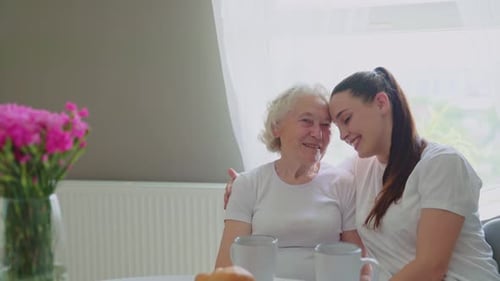 Loving Senior Woman with Young Adult Friend Smiling