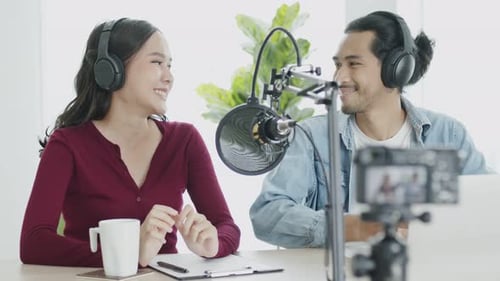 Audio Podcast studio and radio online, portrait Asian woman and man working using microphone and lap