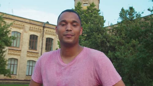 Smiling Man Standing in front of Brick Building